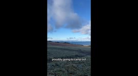 Scotsman films as he sets up tent, fire, and cooks dinner in countryside