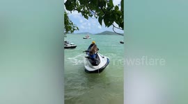 Amusing moment monkey holds onto wobbling jetski