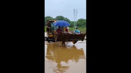 Loaders used to transfer people trapped in floods in Guangxi, China
