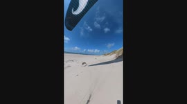 Sighthound Sprints Behind Beach Paraglider