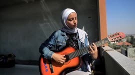 Palestinian student strums songs of hope to soothe broken people in Gaza