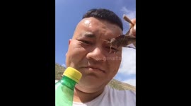 Man eats LIVE locust in China