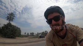 Overloaded tractor-taxi amuses onlookers on Karachi highway