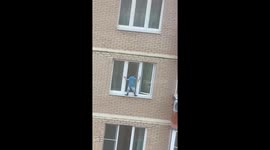 Child balances on 11th floor window sill