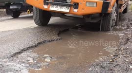 Tourists' vehicles trapped in gridlock as they navigate numerous potholed roads in Indonesia