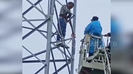 China: Firefighters Save Man Climbing Electrical Tower Amid Marital Dispute