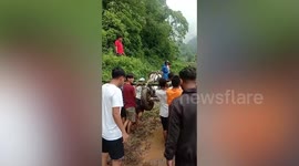 Nepal residents navigate muddy hillside as storms kill 20