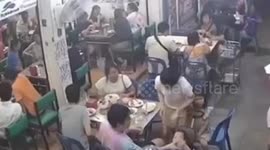 Wall fan explodes and falls onto restaurant table