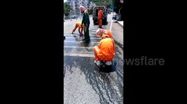 Controversy erupts as Chinese sanitation workers kneel in heat to clean zebra crossings