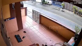 Motorcycle rider slips over while trying to park on wet tiles