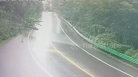 Woodland cascades into road during storm in China