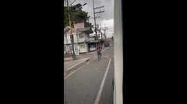 Cyclist rides with python wrapped around his shoulders