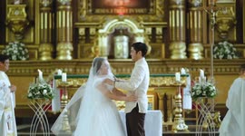 Shy bride laughs uncontrollably during first kiss at wedding