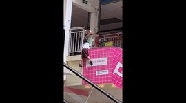 Chinese boy heroically holds friend dangling out of escalator until woman comes to help