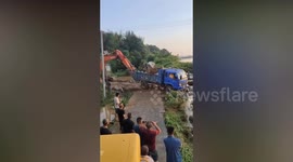 Lorry filled with boulders used to plug breached dam in China