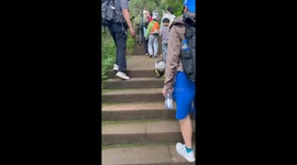 Chinese man and goose race up a mountain