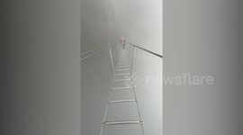 Breathtaking moment hikers cross misty 'ladder to heaven' over massive drop