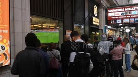 People in Coventry Street in London's West End  watch the big England game