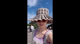 Wind turns hat brim up, creating stylish moment