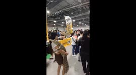 Woman carries her pet crocodile around trade show