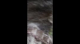 Hikers climb steps during heavy rain in China