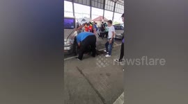 Monitor lizard pulled from under car in Thailand