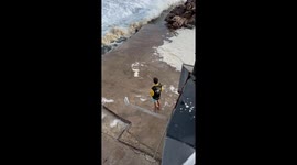 The video shows a few people narrowly escaping a big wave. It was a close call!