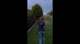 Woman Astonished By Lighting While Mowing