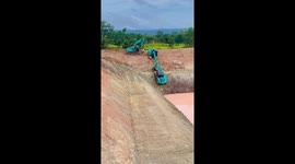 What are friends for! Two excavators help another climb up steep bank