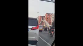 Brave road user rides motorcycle over bridge arch to dodge traffic jam