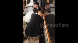 Staff and passengers save woman from gap between train and platform in China