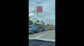 Five broken-down cars all dragged in a chain by tow truck