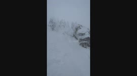 skier drops cliff straight into his friend