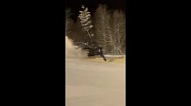 skier lands a trick on a jump then get eaten by the side of the landing