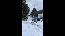 guy on snowboard tries to hit a bike rack rail and falls on face