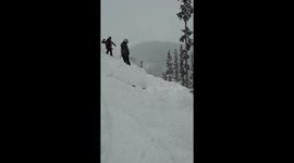 snoboarder tries to grind on a tree and falls onto the tree