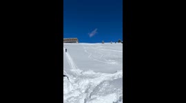 male skier attempts double back flip and lands on his head in the snow