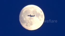 Planes fly through the July Full Moon known as the Buck Moon