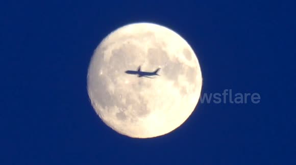Planes fly through the July Full Moon known as the Buck Moon