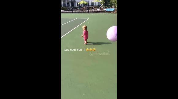 Big brother and little sister playing with a ball, but brother decides to throw ball in her face