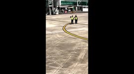 Airport ground workers wave goodbye to travellers