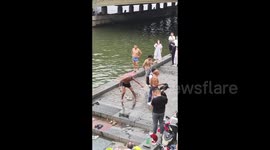 China: Elderly Man Preps for Swim in Tianjin with Unique Warm-Up Routine