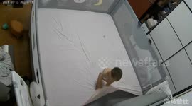 Mischievous baby keeps lifting up neatly arranged bed sheet