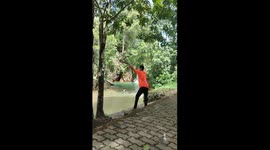 Person jumps into water, lands on another swimmer