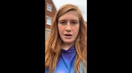 Snack time struggle: Girl struggles to crack open a bag of chips  