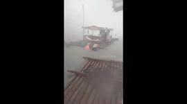 Residents battle strong winds and floods to save floating cottages at Matabungkay Beach