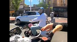 Traffic cop stunned by helmetless scooter riders' bizarre face masks in China