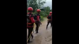 Firefighters save 3 men trapped in flooded river in China's Hainan