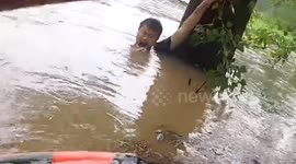 Chinese man trapped in deep floodwater rescued after sharing location with phone in mouth