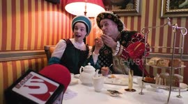 Horrible Histories Terrible Tudors stars Neal Foster and Emma Swan in character pose with their scones.